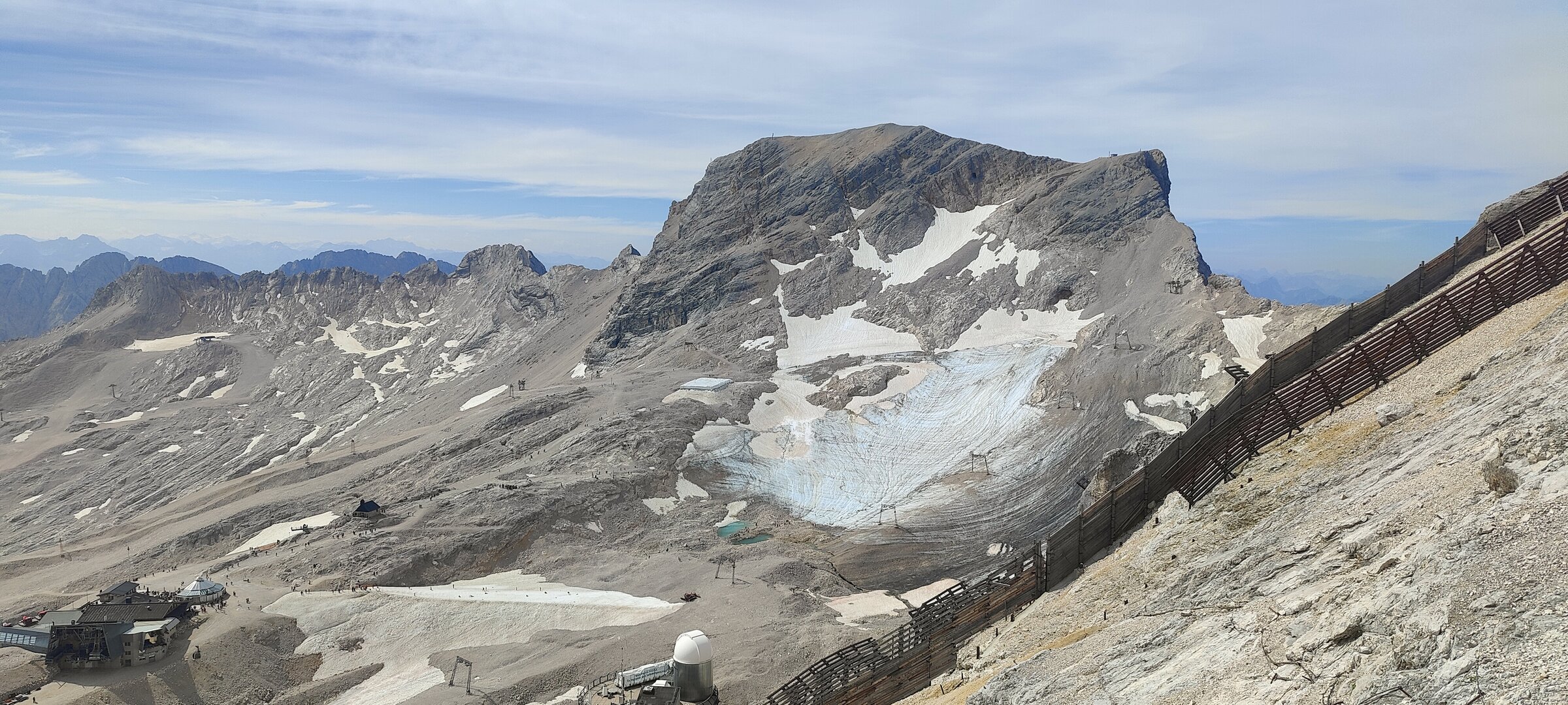 High alpine terrain approaching the summit — glacial remnants and raw rock at over 2,700 m