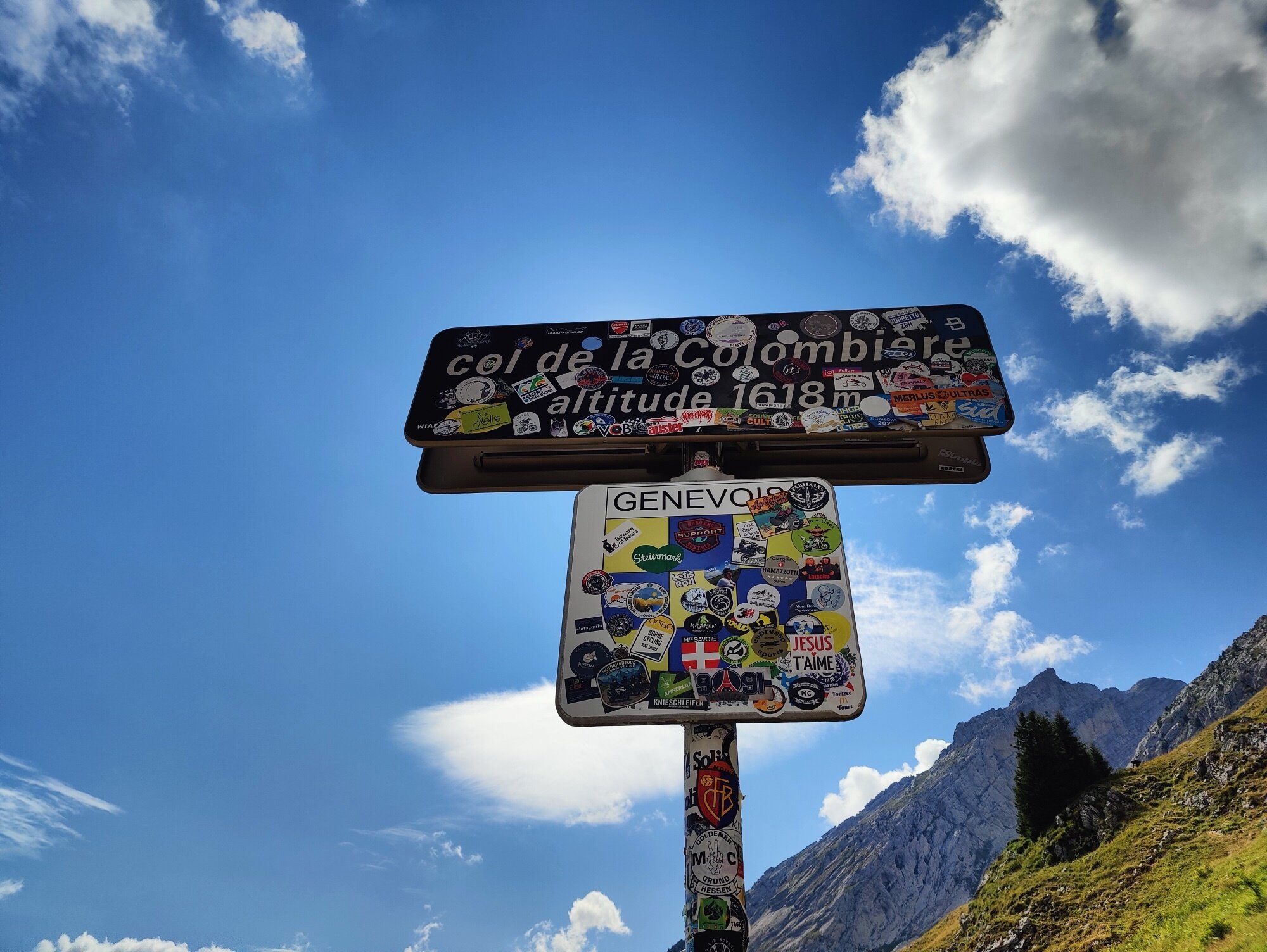 Le panneau du Col de la Colombière couvert d'autocollants à 1 618 m
